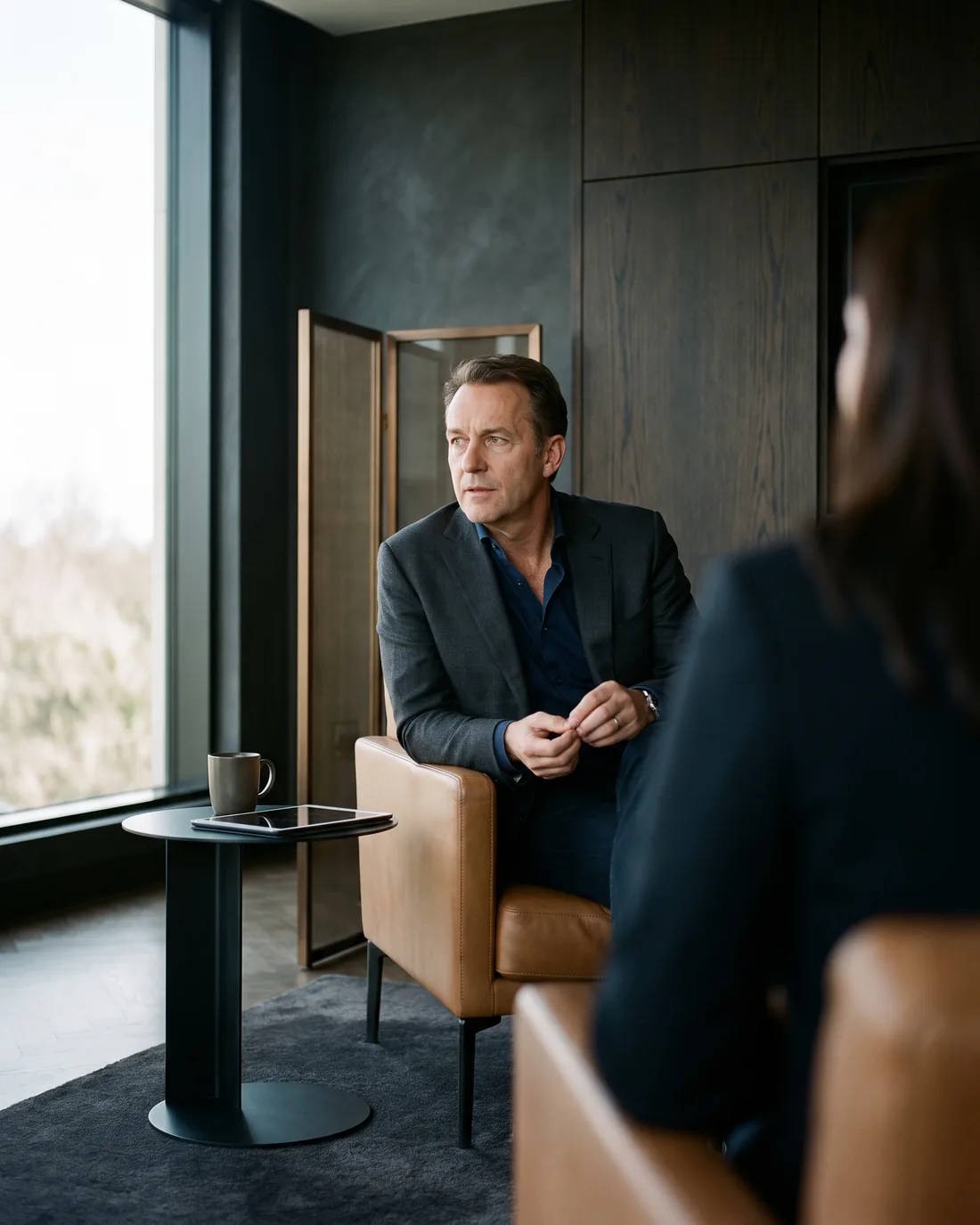A senior CHRO reviewing the work in a calm Luxembourg boardroom